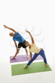 Royalty Free Photo of a Man and Woman Stretching on Exercise Mats