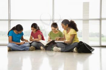 Royalty Free Photo of Girls of Sitting Together on the Floor With Schoolwork