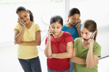Royalty Free Photo of Preteen Girls Talking on a Cellphone