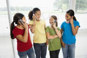 Royalty Free Photo of Preteen Girls Talking on Cellphones