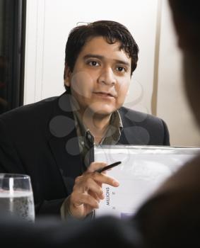 Royalty Free Photo of a Businessman in a Meeting With Charts