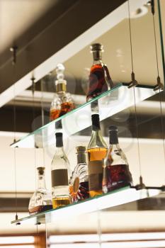Royalty Free Photo of Glass Shelves With Liquor Bottles