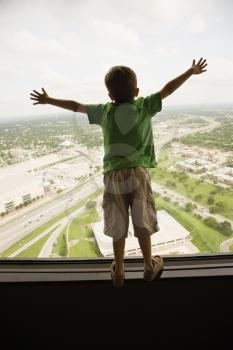 Royalty Free Photo of a Young Boy standing on observation deck at Tower of the Americas in San Antonio, Texas