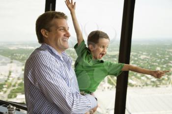 Caucasian father and son at observation deck at Tower of the Americas in San Antonio, Texas.