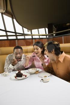 Royalty Free Photo of a Small Group of Friends Eating Dessert at a Restaurant