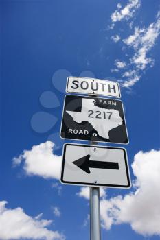 Royalty Free Photo of a Highway Sign Denoting South Texas Farm Road With an Arrow