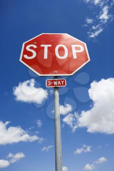 Royalty Free Photo of a Stop Sign With Blue Cloudy Sky