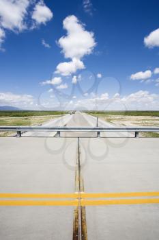 Royalty Free Photo of a Solid Double Yellow Line in a Road on an Overpass With Highway Below