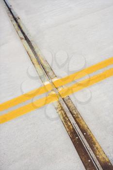 Royalty Free Photo of a Detail of Solid Double Yellow Lines in the Road in Cement
