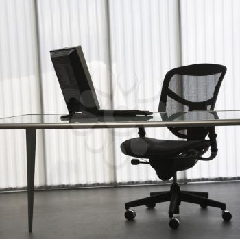 Royalty Free Photo of an Empty Office With a Desk, Computer and Chair