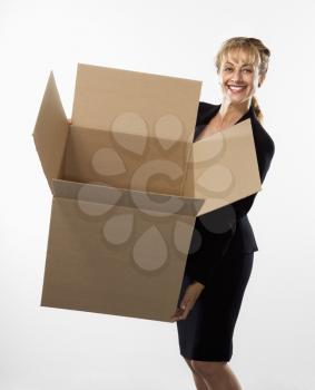 Royalty Free Photo of a Businesswoman Standing Holding an Empty Cardboard Box