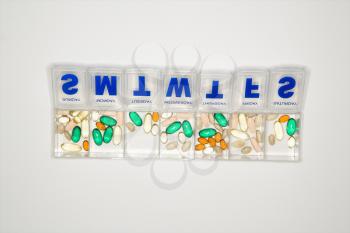 Royalty Free Photo of a Weekly Container With Pills and Vitamins