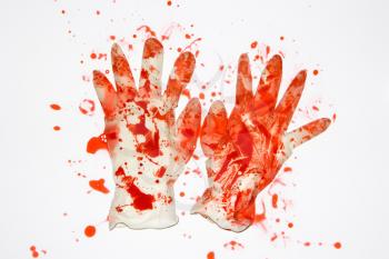 Royalty Free Photo of a Pair of Rubber Gloves With Blood Splattered on Them