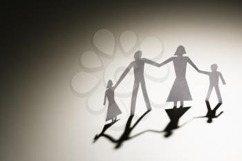 Royalty Free Photo of a Paper Cutout Family of Four Standing Holding Hands