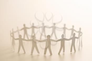 Royalty Free Photo of Cutout Paper People Standing in a Circle Holding Hands