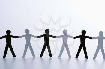 Royalty Free Photo of Black and White Cutout Paper People Holding Hands
