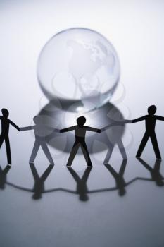 Royalty Free Photo of Cutout Paper People Standing Around an Earth Globe Holding Hands