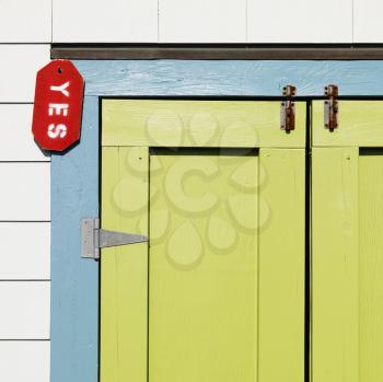 Royalty Free Photo of a Detail of Colorful Doors With a Sign Reading 'yes' at Bald Head Island, North Carolina