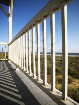 Royalty Free Photo of a Detail of a Wooden Railing on a Porch Overlooking Beach at Bald Head Island, North Carolina