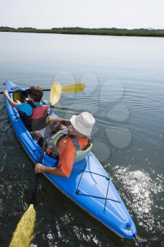 Royalty Free Photo of a Couple Paddling Kayak