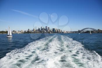 View from water of boats and skyline of  Sydney, Australia.