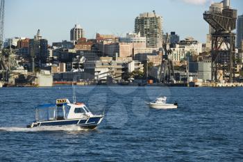 Royalty Free Photo of a Water Taxi Boat in Sydney, Australia With City Buildings
