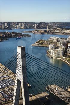 Aerial view of Anzac Bridge and buildings by harbour in Sydney, Australia.