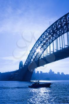 Royalty Free Photo of a Boat Under the Sydney Harbour Bridge in Sydney, Australia