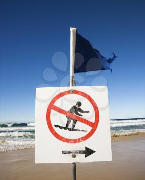 Royalty Free Photo of a No Surfing Sign and Flag on a Beach at Surfers Paradise, Australia