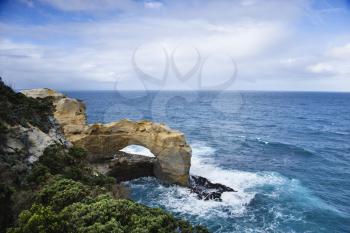 Royalty Free Photo of a Rock in an Arch Shape on the Coastline of Australia as seen from Great Ocean Road