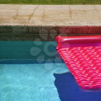 Royalty Free Photo of a Pink Float in an Empty Swimming Pool