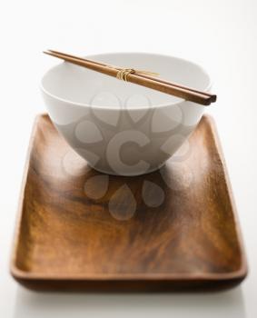 Royalty Free Photo of a Bowl With Chopsticks on a Wooden Tray