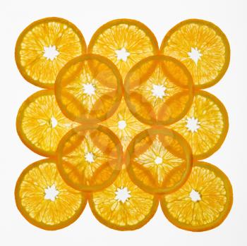 Orange slices arranged in square design on white background.