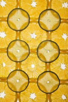 Royalty Free Photo of Orange and Lime Slices Arranged in a Design on a White Background
