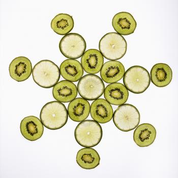 Royalty Free Photo of Lime and Kiwi Fruit Slices Arranged on a White Background