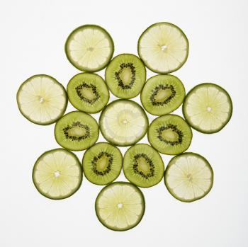 Kiwi and lime fruit slices arranged on white background.