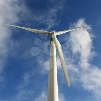 Royalty Free Photo of a View of Wind Turbine Against a Blue Sky and Clouds