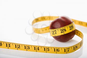 Royalty Free Photo of a Measuring Tape Wrapped Around Nectarine