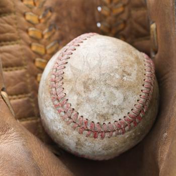 Royalty Free Photo of a Baseball Resting in a Baseball Glove