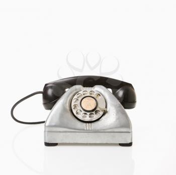 Royalty Free Photo of a Rotary Telephone With a Black Receiver