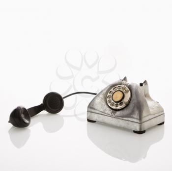 Royalty Free Photo of a Rotary Telephone With the Receiver to the Side