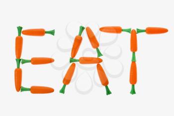 The word eat spelled out with carrots on white background.