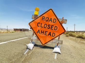Royalty Free Photo of a Road Sign on a Rural Highway Warning That a Road is Closed Ahead