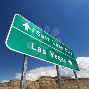 Royalty Free Photo of a Road Sign in the Desert Pointing Towards Salt Lake City and Las Vegas