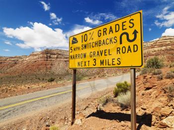 Royalty Free Photo of a Road Sign Warning Steep Grade in Mountainous Utah Landscape
