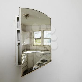 Royalty Free Photo of a Reflection of an Empty Abandoned Dirty Kitchen in a Mirror