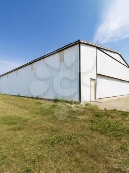 Royalty Free Photo of a Plain Aluminum Building in a Rural Setting