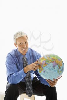 Royalty Free Photo of a Man Pointing on a Globe