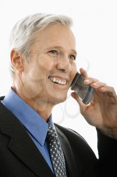 Royalty Free Photo of a Middle-aged Businessman Smiling and Talking on a Cellphone