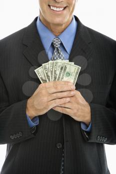 Royalty Free Photo of a Middle-Aged Businessman Holding a Fist Full of Cash